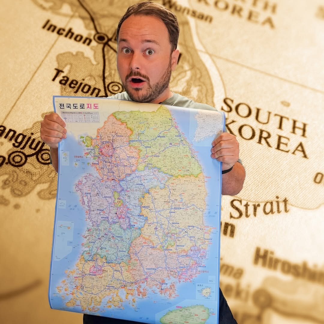 Benny holding up a Korean road map of South Korea's provinces