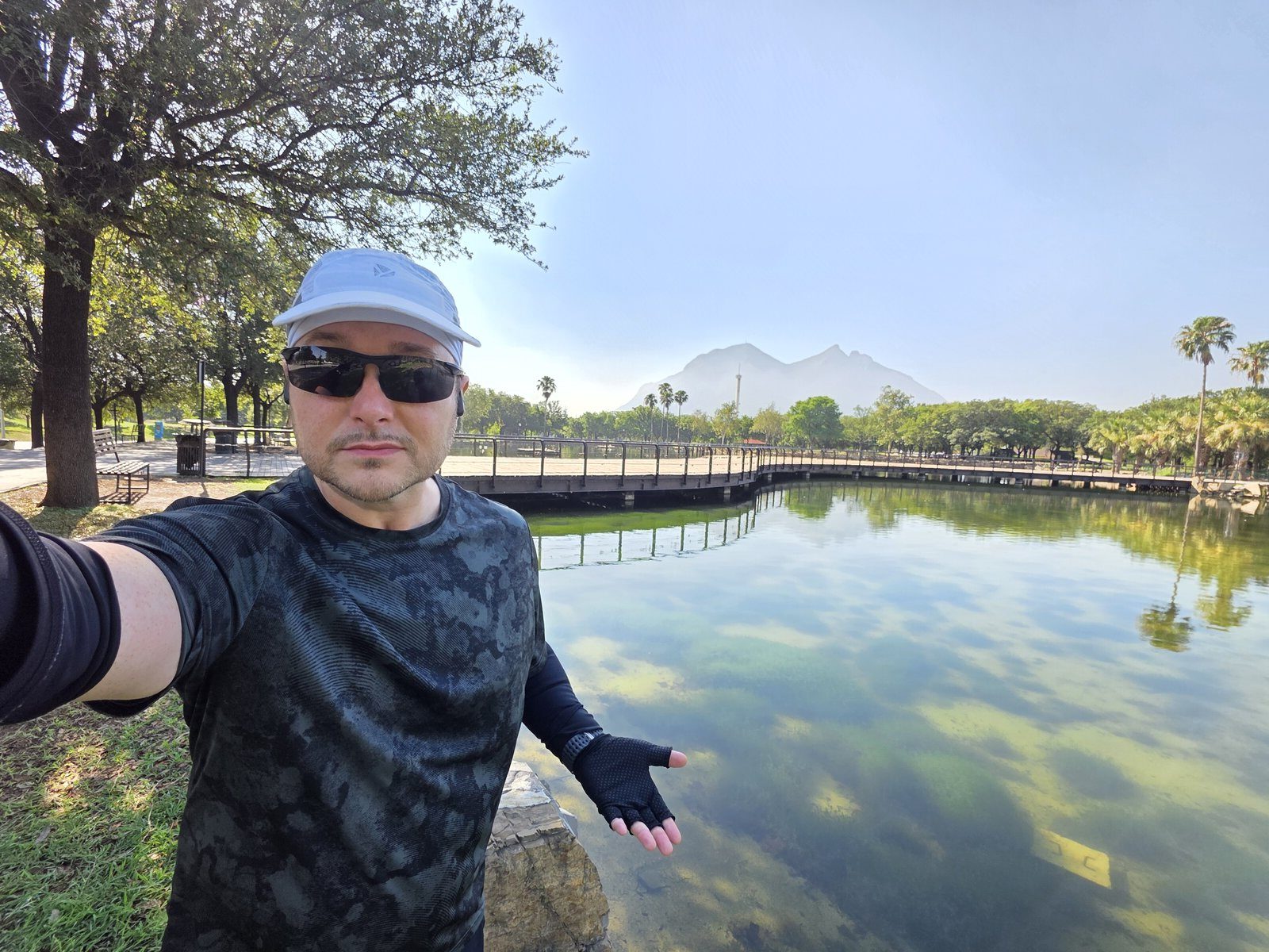 Benny at a park lake in Monterrey, Mexico, with the Cerro de la Silla mountain in the background