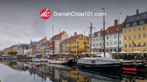 DanishClass101 logo over the coloured harbour houses of Nyhavn, Copenhagen