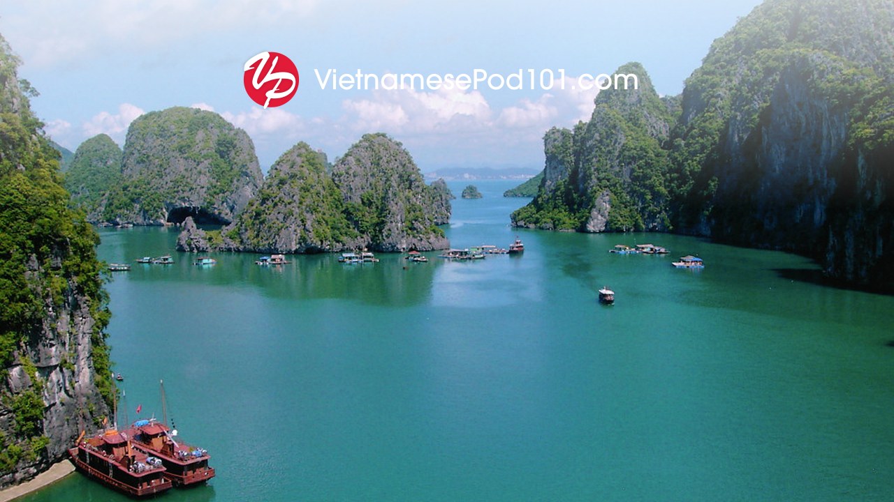 VietnamesePod101 logo over the limestone karsts and boats of Ha Long Bay, Vietnam