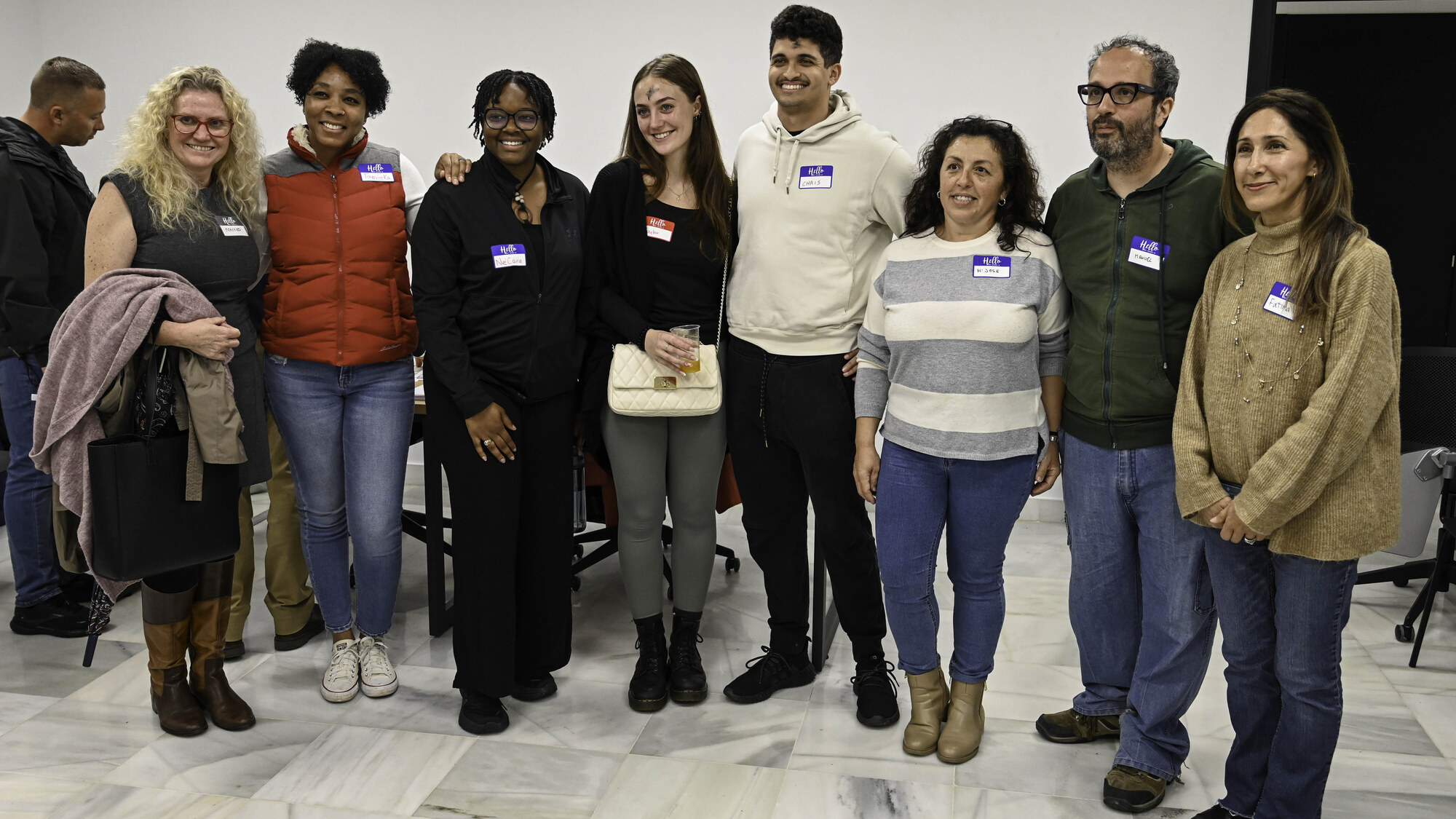 Spanish and English learners wearing name tags at a language exchange in Rota, Spain