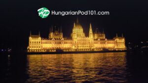 HungarianPod101 logo over the Hungarian Parliament Building beside the Danube in Budapest