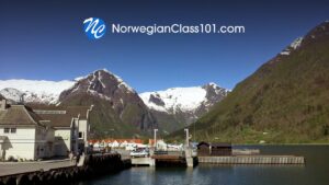 NorwegianClass101 logo over a Norwegian fjord harbour and mountains