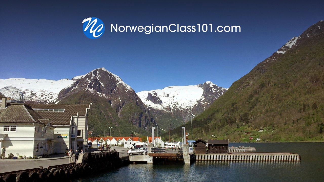 NorwegianClass101 logo over a Norwegian fjord harbour and mountains
