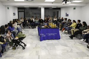 Adults seated in a conversation circle at a Spanish–English language exchange in Rota, Spain