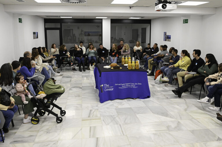 Adults seated in a conversation circle at a Spanish–English language exchange in Rota, Spain