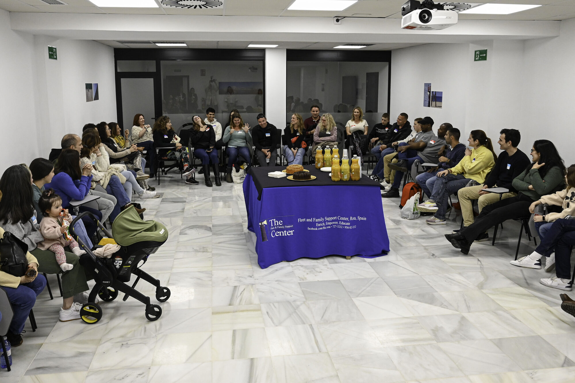 Adults seated in a conversation circle at a Spanish–English language exchange in Rota, Spain